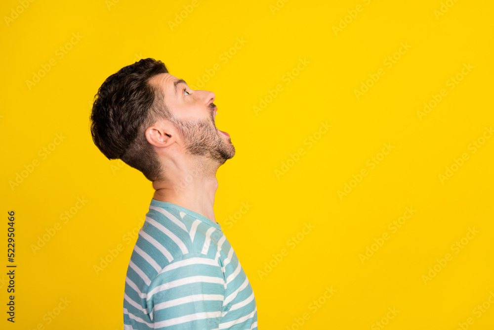 Sticker profile photo of impressed guy look up wear striped t-shirt isolated on yellow color background