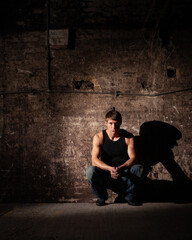 Shadowplay. Series of images of casually dressed models in a dark and industrial setting...