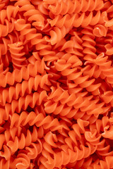 Whole, lentils fusilli pasta background.