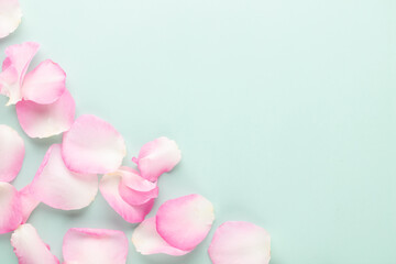 Obraz na płótnie Canvas Rose flowers petals on pastel background. Valentines day background. Flat lay, top view, copy space.