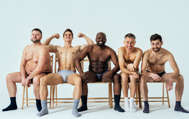 group of multiethnic men posing for a male edition body positive beauty set. Shirtless guys with...