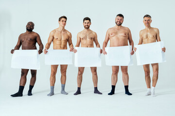 multiethnic men posing for a male edition body positive beauty set showing messages on banners....