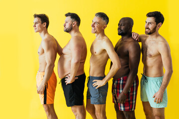 group of multiethnic men posing for a male edition body positive beauty set. guys with different...