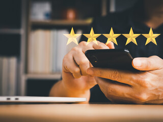Man's hand holding mobile phone to rating score or survey feedback. Five stars virtual screen...