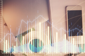 Multi exposure of forex graph hologram over desktop with phone. Top view. Mobile trade platform...