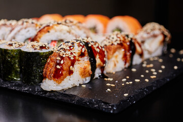 Japanese traditional cuisine. Close up of delicious sashimi sushi on black board.