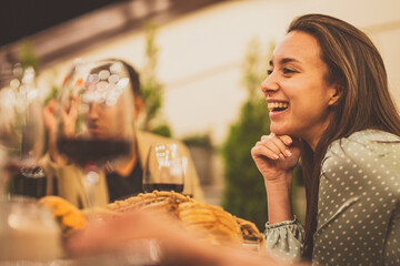 Family and friends celebrating at dinner on a rooftop terrace