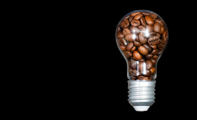 Dark roasted coffee beans inside a clear lightbulb