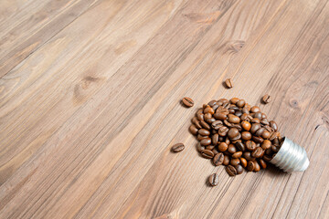 Roasted coffee beans arranged into a light bulb