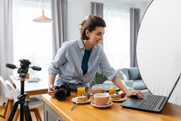 blogging, photographing and people concept - happy smiling female food blogger or photographer with...