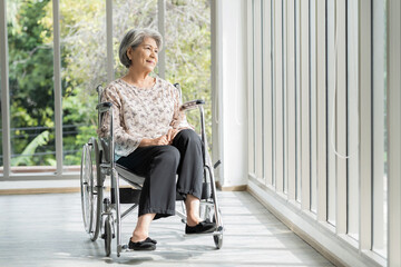 Elderly adult retired asian woman sit on wheelchair at home. Smiling asian senior old grandma sit on wheelchair at hospital