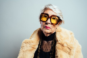 image of a beautiful and elegant old influencer woman. Cool grandmother posing in studio wearing...