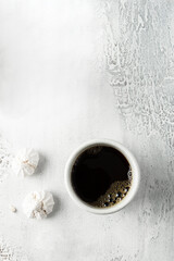 A cup of coffee and american cookies with chocolate chips on grey background. Top view.