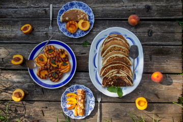 pancake with fresh peaches on a vintage plate