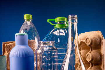 A large cardboard box of sorted and recyclable garbage is on the table. The concept of reuse of resources and respect for the environment.