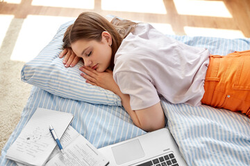 school, education and laziness concept - tired teenage student girl with laptop computer and...