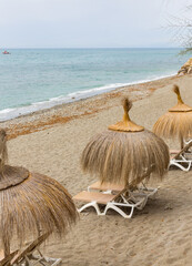 A beach with natural fiber umbrellas to protect you from the sun