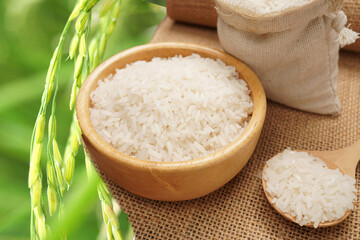 many white rice grains in a cup Green leaf background, blurry, or blurry (spot focus)