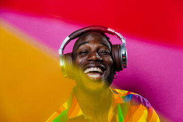 artistic portrait with gel lights. Handsome man posing on colored backgrounds. Artist singer...