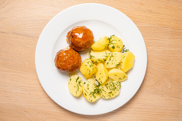 cutlet with baked potato on wooden background