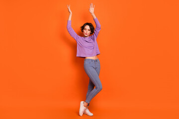 Full size portrait of gorgeous nice lady enjoy dancing spend free time isolated on orange color background