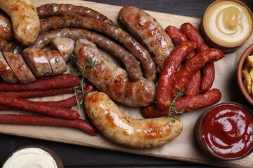 Set of different tasty snacks on wooden table, top view