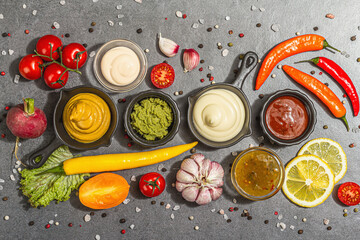 Set of sauces and fresh vegetables. Ketchup, mustard, mayonnaise, wasabi, sweet curry, and BBQ