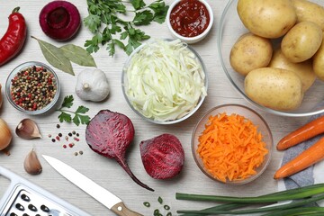 Fresh ingredients for borscht on white wooden table, flat lay