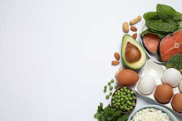 Different products rich in protein on white background, flat lay