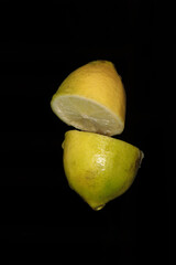 Yellow lemon slices isolated on black background macro close up