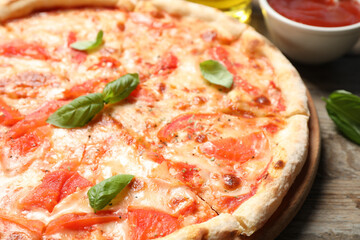 Delicious pizza Margherita on wooden table, closeup view