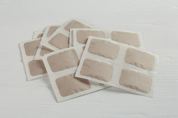 Pile of mustard plasters on white wooden table