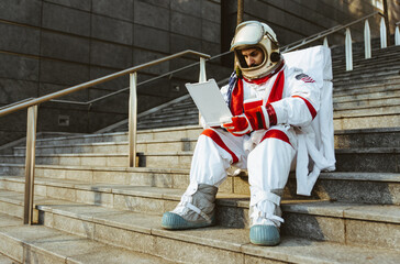 spaceman in a futuristic station. Man with space suit walking in an urban area