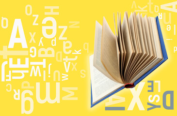Flying open book with letters on yellow background. Dyslexia concept