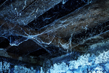 a creepy spider web hanging from the ceiling of an old abandoned house