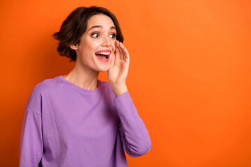 Photo of crazy amazed person hand near open mouth look empty space isolated on orange color background