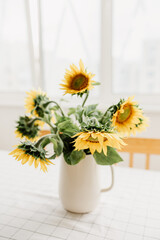 Sunflowers bouquet in vase on the table