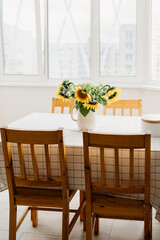 Sunflowers bouquet in vase on the table