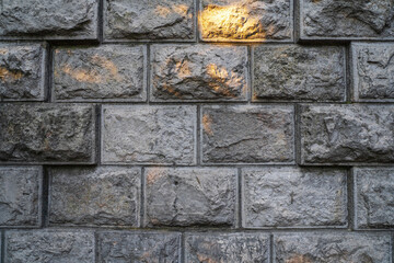 texture of a grey stone wall made of stones with concrete