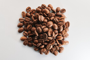 Roasted coffee beans isolated close up on white background, clipping path