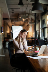 Happy businesswoman working on laptop. Portrait of beautiful businesswoman in the office..