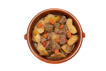 An earthenware bowl with hungarian goulash, beef, pork stew with potatoes, isolated on white background. It is a spicy dish, made mainly with meat, onions, peppers and paprika.