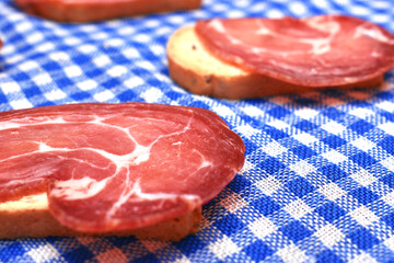 woman eating some toast with iberian cured ham
