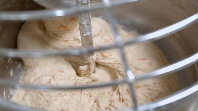 Dough for bread with dried apricots is mixed in dough machine