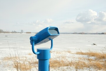 touristic telescope look at the city with view winter landscape , closeup binocular on background...