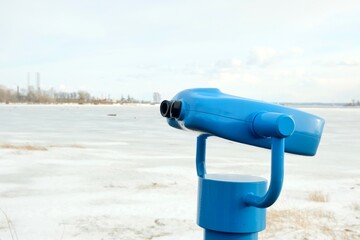 touristic telescope look at the city with view winter landscape , closeup binocular on background...