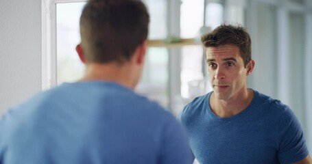 Beauty, grooming and shaving with a handsome man looking at his reflection in the mirror at home and feeling confident, sexy and charming. Male getting ready for the day in the bathroom and smiling - Powered by Adobe