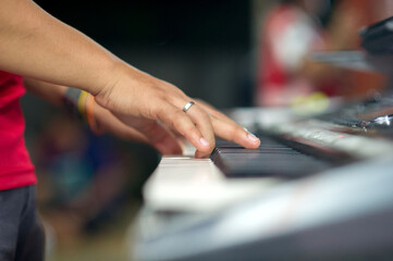 Closeup hands playing the keyboard or piano on brand music instrument background, music concept