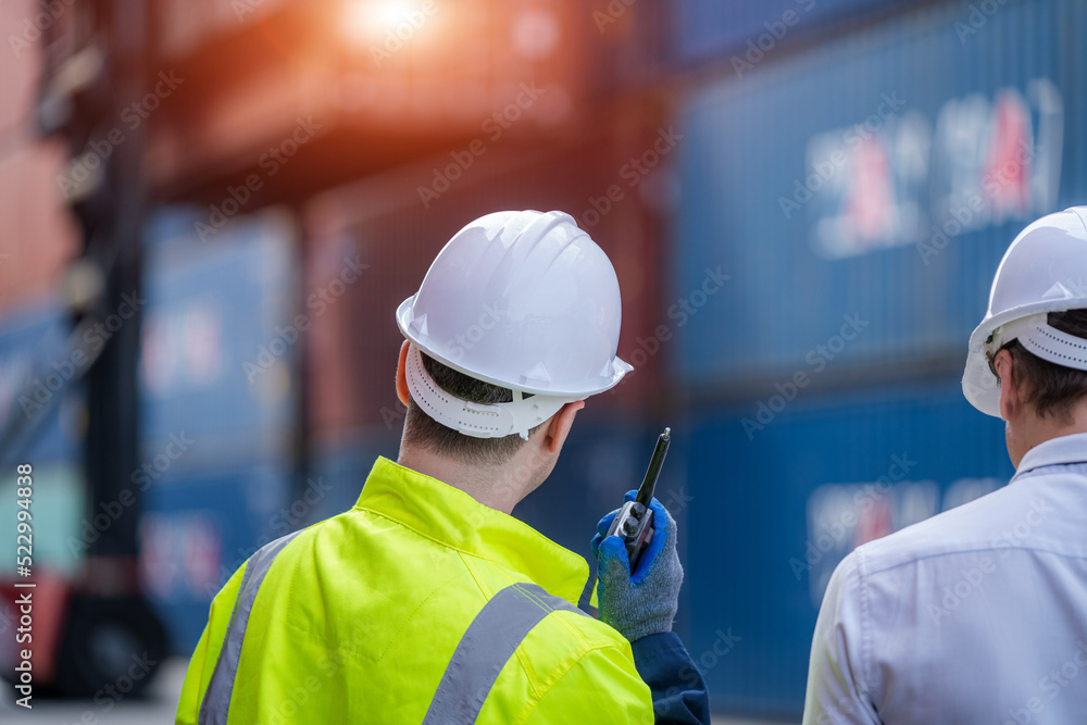 Poster Engineer and inspector working and discuss in shipping container in Container Terminal.