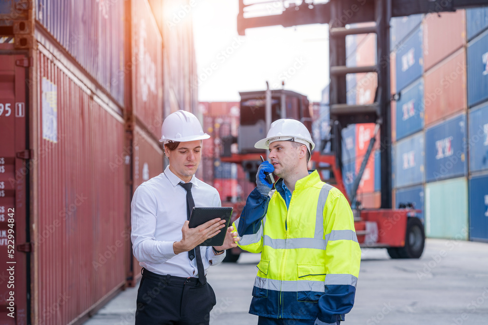 Poster Manager and worker working checking stock into container for loading,Logistic and business export.
